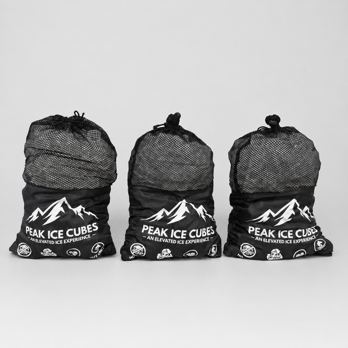 Three bags of PEAK Ice Cubes on a clean studio background